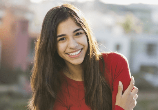 girl in red shirt smiling