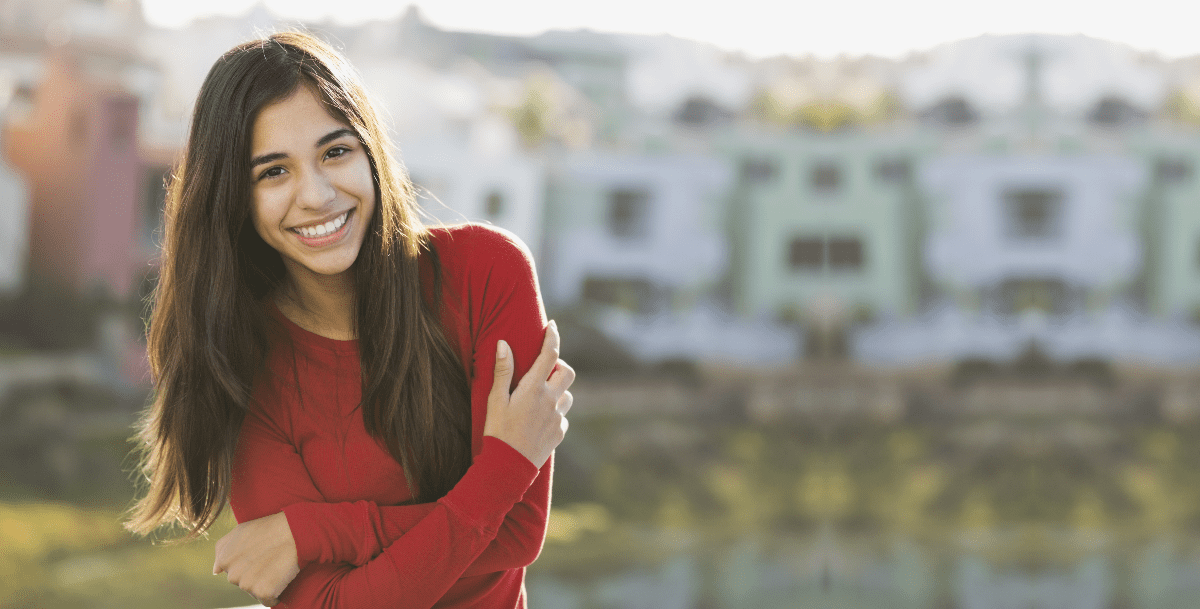 girl in red shirt smiling