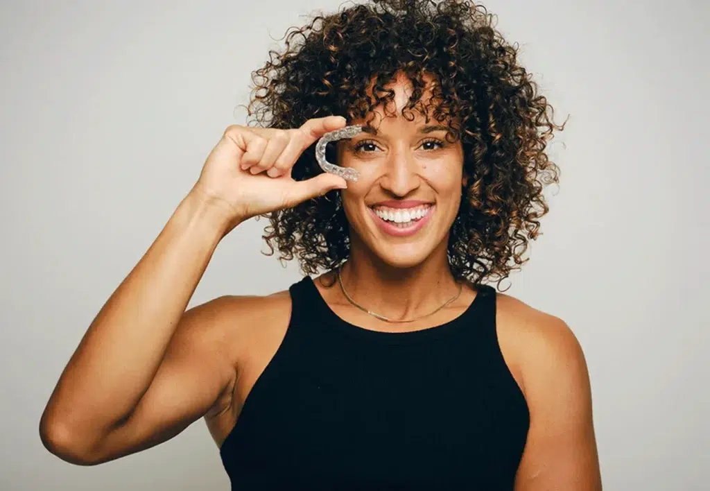 Pretty Woman Holding Clear Aligners